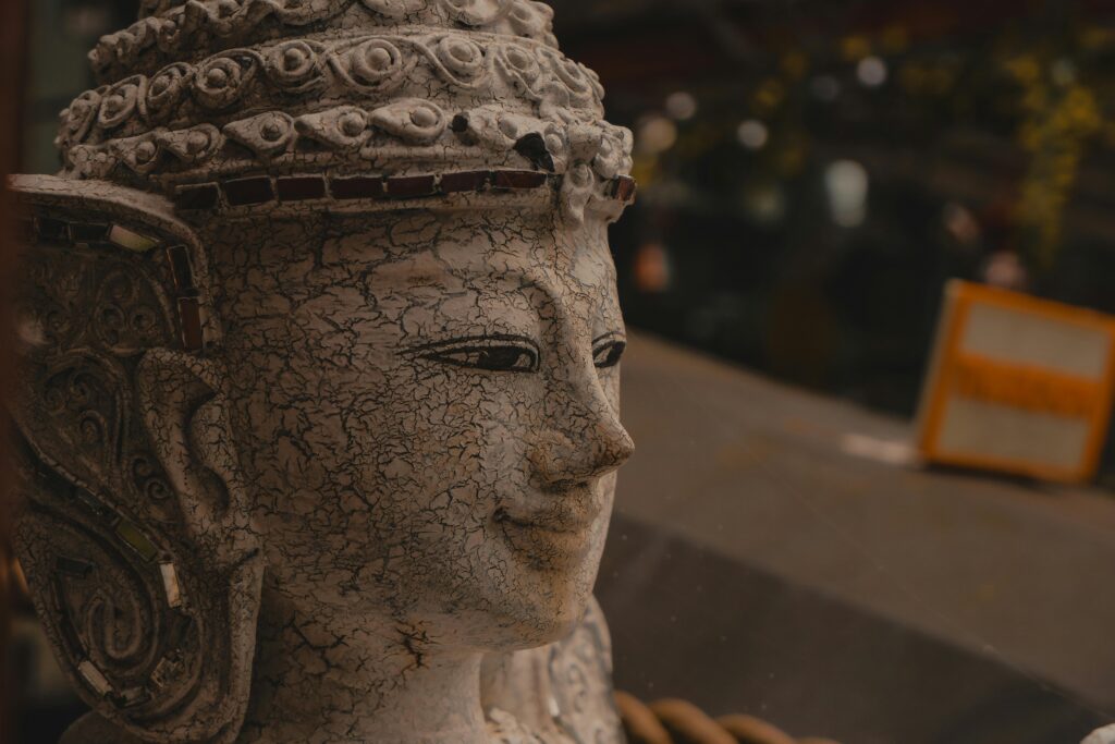 A detailed view of a weathered Buddha statue capturing its serene expression and intricate design.